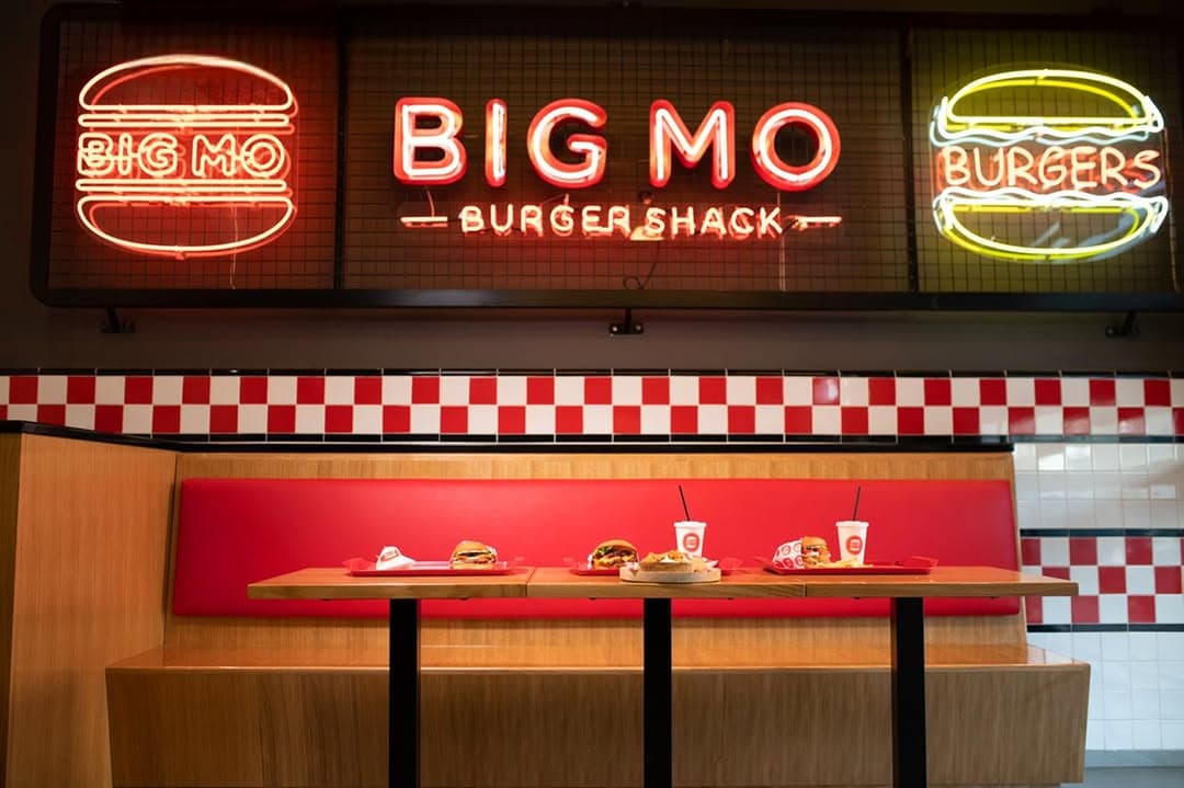 A BIG MO dining area with checkerboard floors and booth seating